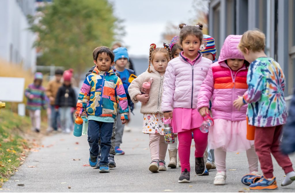 PreK students at Bancroft School in Worcester, MA walking outside.