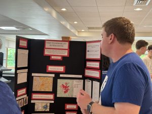 Student at bancroft School in Worcester, MA explains their Senior Co-Op project at the Co-Op Fair.