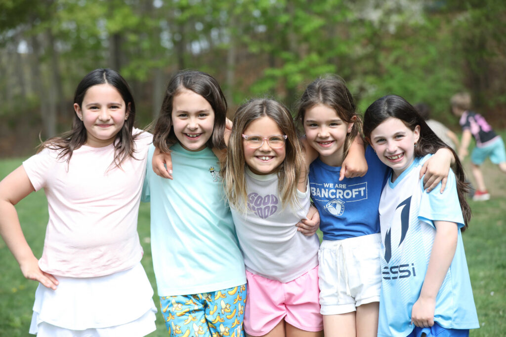 Happy students outside arm in arm