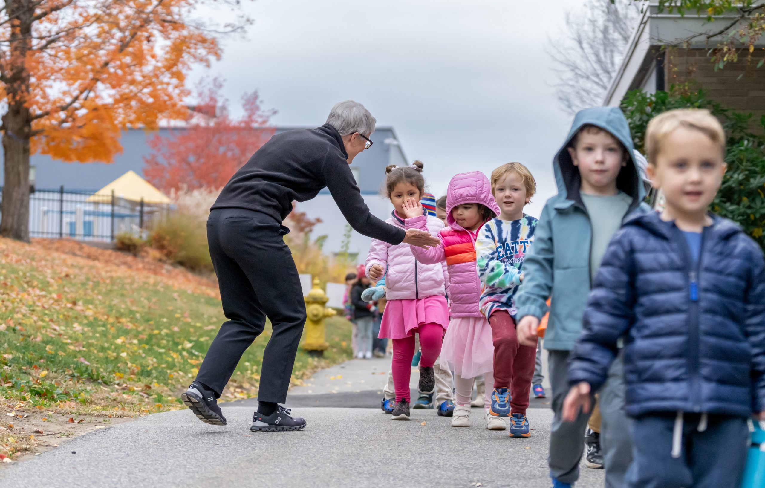 Bancroft School PreK students walking along a path.
