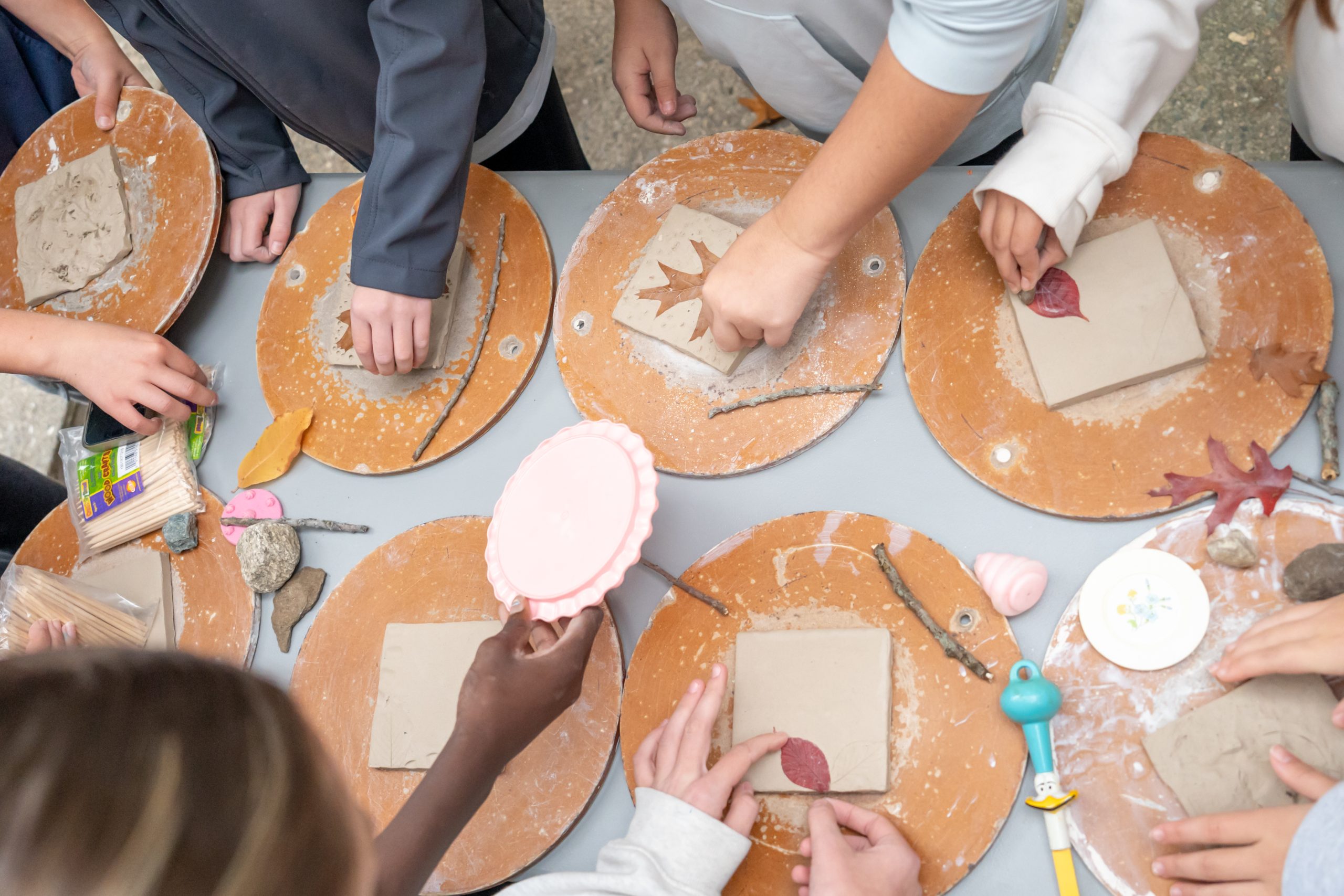 Photo of student hands as they make art.