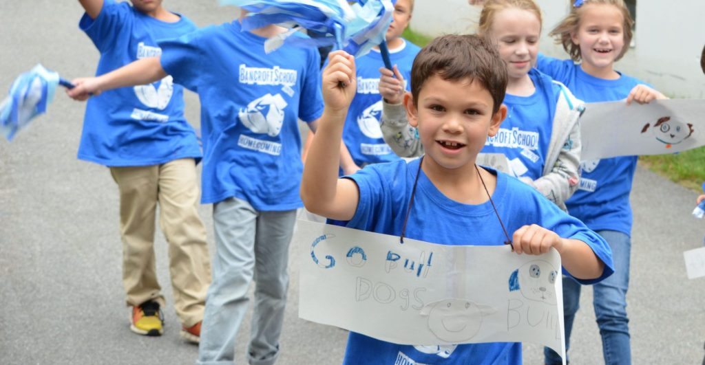 Young students walking along a path at Bancroft School in Worcester on their way to a pep rally.