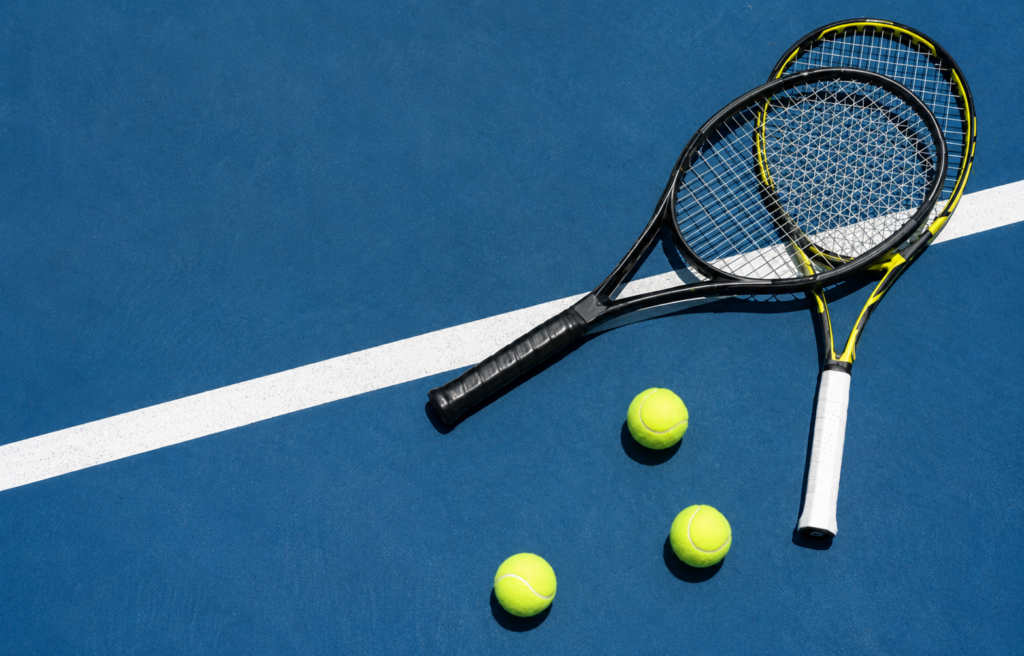Two tennis rackets on a tennis court.