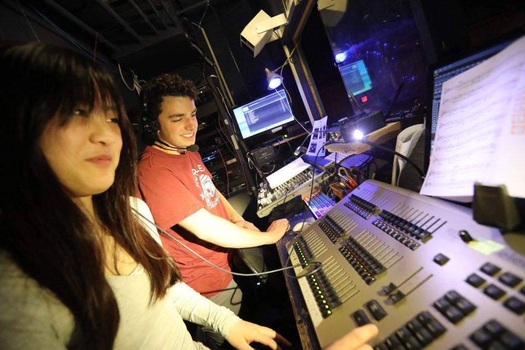 Bancroft School in Worcester, MA a photo of students running the lights nad sound for a stage production.