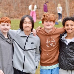 Students at Bancroft School arms around one another on the playground.
