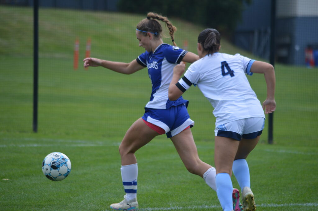 Varsity soccer players competing for the ball at Bancroft School in Worcester, MA.