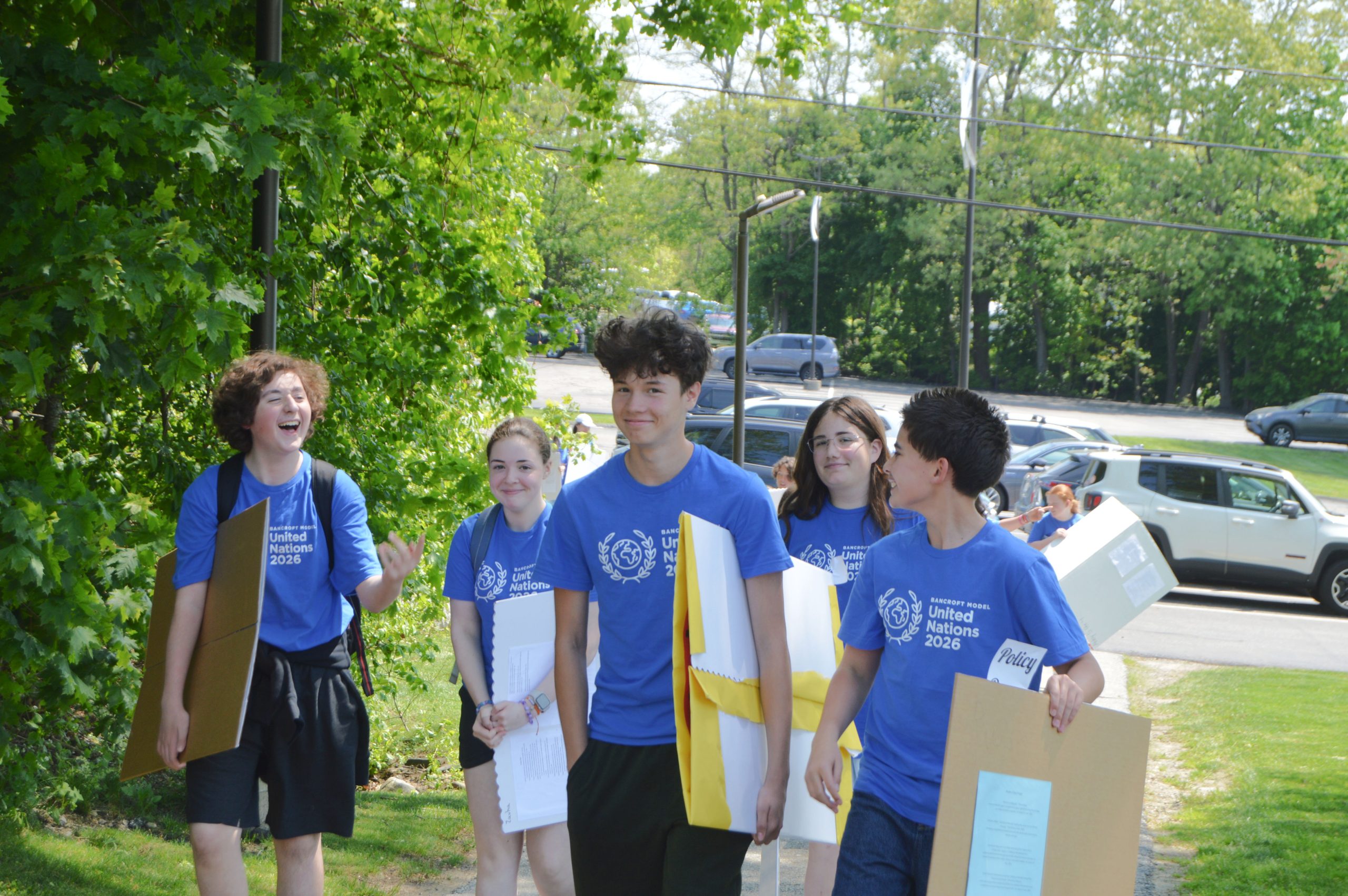 Bancroft School students walking wearing Model UN shirts.